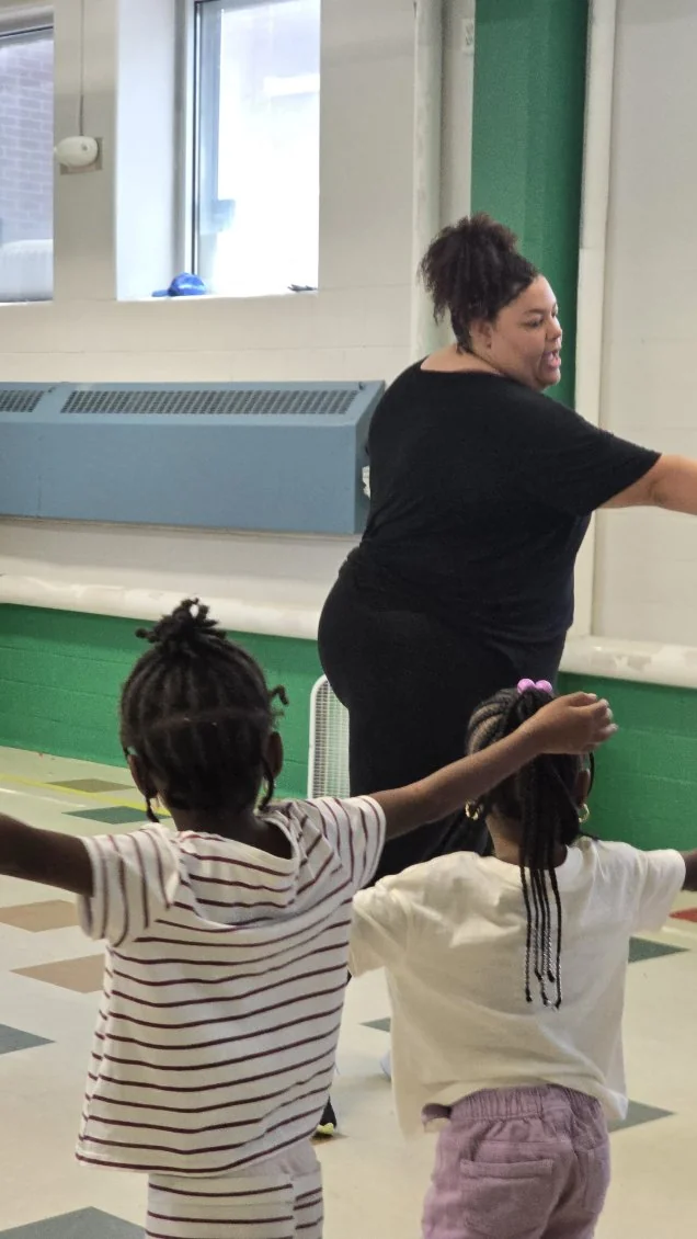 Miss Niki leading two young dancers with arms outstretched in a Liberated Movement class at Time to Dance